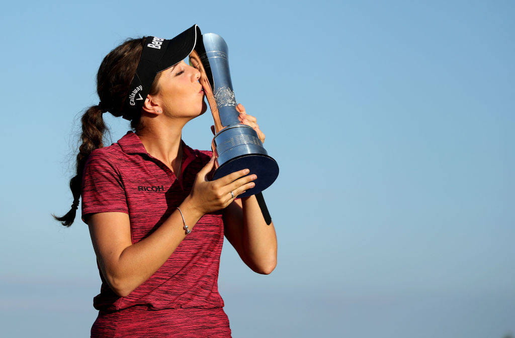 Georgia Hall kisses the trophy after winning the AIG Women